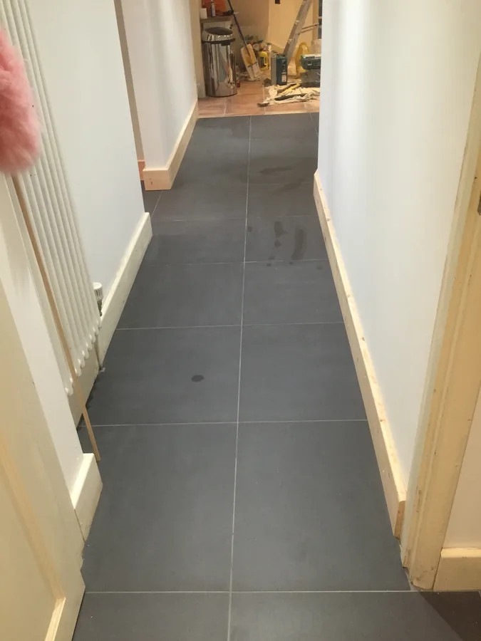 Large-format floor tiling in a narrow hallway
