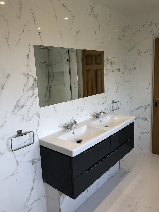 Double vanity unit against a marble-effect tiled wall