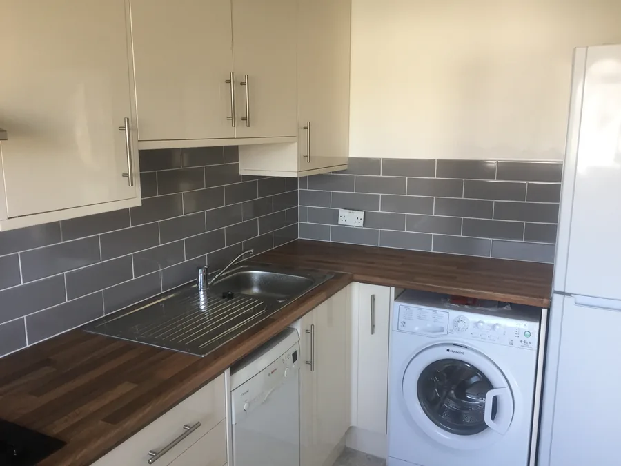 Grey metro-tile splashback running along the worktop