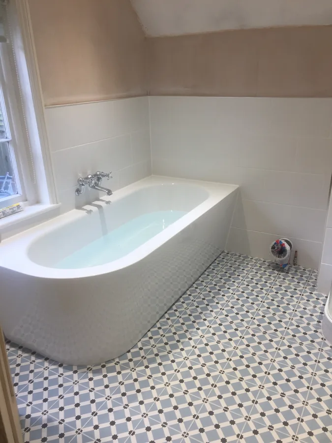 Bath above a patterned encaustic-style tiled floor