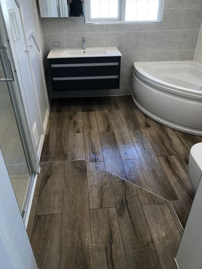 Bathroom with wood-effect plank floor tiling and vanity unit